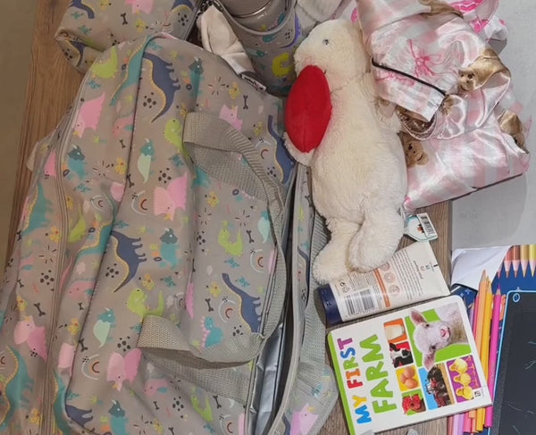 Packing the extra large kids weekender bag (Dinky Dinos shown) – shoes in the waterproof bottom pocket, clothes, toys and wash bags in the main compartment. Also available in Diggers & Lorries, Fabulous Fairies and Farmyard Family.